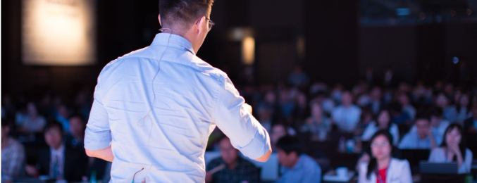 A presenter addresses a conference audience